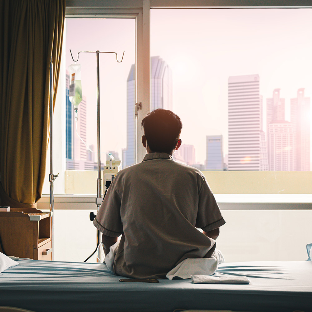 Doctor-sat-on-hospital-bed